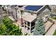 Two-story house with solar panels, brick accents, and an outdoor patio with a shade covering at 23426 E Ottawa Dr, Aurora, CO 80016
