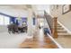 Elegant foyer showcasing a staircase, hardwood floors, dining area, and high ceilings at 23426 E Ottawa Dr, Aurora, CO 80016