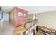 Hallway featuring wood and iron railing and an open view to the kitchen at 23426 E Ottawa Dr, Aurora, CO 80016