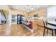Well-equipped kitchen with a center island, stainless steel appliances, wooden cabinets and wood floors throughout at 23426 E Ottawa Dr, Aurora, CO 80016
