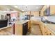 Bright kitchen with wooden cabinets, granite countertops, stainless steel appliances, and a cozy breakfast nook and fireplace at 23426 E Ottawa Dr, Aurora, CO 80016