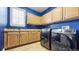 Laundry room featuring modern washer and dryer, cabinets, and counterspace at 23426 E Ottawa Dr, Aurora, CO 80016