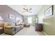 Comfortable living room featuring neutral tones, a ceiling fan and bright natural light at 23426 E Ottawa Dr, Aurora, CO 80016