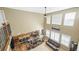 Bright living room featuring high ceilings, many windows, wood floors, and an open layout connecting to the kitchen area at 23426 E Ottawa Dr, Aurora, CO 80016