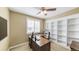 Office space showcasing a wooden desk, built-in shelves, and bright, natural light at 23426 E Ottawa Dr, Aurora, CO 80016