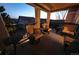 Cozy covered patio with seating and neighborhood views at dusk, perfect for outdoor entertaining and relaxing at 23426 E Ottawa Dr, Aurora, CO 80016