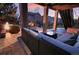 Relaxing covered patio with comfortable seating, a coffee table, and a fire pit offering a cozy outdoor space at 23426 E Ottawa Dr, Aurora, CO 80016