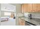 Convenient wet bar area adjacent to bedroom with granite counters and cabinets at 23426 E Ottawa Dr, Aurora, CO 80016