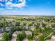 Stunning aerial view of the neighborhood, showcasing the mature trees, green golf course, and community at 3901 Stonegrass Pt, Broomfield, CO 80023