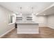Basement bar with granite countertop, modern lighting, and floating wood shelves at 3901 Stonegrass Pt, Broomfield, CO 80023