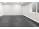 The unfinished basement has rubber flooring and a window allowing natural light at 3901 Stonegrass Pt, Broomfield, CO 80023