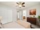Bedroom with soft carpet, ceiling fan, closet doors and bathroom at 3901 Stonegrass Pt, Broomfield, CO 80023