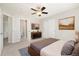 Bedroom with soft carpet, ceiling fan, closet doors and bathroom at 3901 Stonegrass Pt, Broomfield, CO 80023