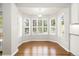 Dining area with large windows and hardwood floors at 3901 Stonegrass Pt, Broomfield, CO 80023
