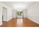 Empty dining room with tray ceiling, hardwood floors and large window at 3901 Stonegrass Pt, Broomfield, CO 80023