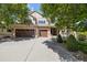 Charming exterior with three-car garage, manicured yard and front porch at 3901 Stonegrass Pt, Broomfield, CO 80023
