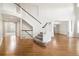 Grand foyer features high ceilings, hardwood floors, and a sweeping staircase at 3901 Stonegrass Pt, Broomfield, CO 80023