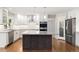 Bright kitchen features granite counters, stainless appliances and an island with seating at 3901 Stonegrass Pt, Broomfield, CO 80023