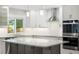 Modern kitchen features white cabinets, granite countertops, and stainless steel appliances at 3901 Stonegrass Pt, Broomfield, CO 80023