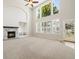 Bright living room featuring fireplace and large windows with plantation shutters at 3901 Stonegrass Pt, Broomfield, CO 80023