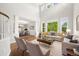 Bright living room boasts soaring ceilings and oversized windows at 3901 Stonegrass Pt, Broomfield, CO 80023