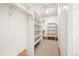 Walk-in closet with shelving and hanging rods for storage and organization at 3901 Stonegrass Pt, Broomfield, CO 80023