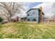 A large backyard with an open lawn and mature trees offers plenty of outdoor recreation space at 4620 W 108Th Pl, Westminster, CO 80031