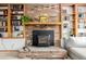 Close-up of the fireplace with brick surround and wooden mantel with built-in shelving at 4620 W 108Th Pl, Westminster, CO 80031