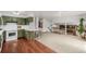Bright kitchen adjacent to large living space, featuring trendy green cabinetry, and modern finishes at 4620 W 108Th Pl, Westminster, CO 80031