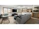 Open-concept living room with a large window, stairs to the kitchen, and comfortable seating at 4620 W 108Th Pl, Westminster, CO 80031