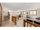 Spacious living room with carpet, comfortable seating, natural light, and unique elevated dining area at 4620 W 108Th Pl, Westminster, CO 80031