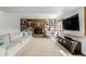 Bright living room featuring a fireplace, built-in shelves, and a large screen television at 4620 W 108Th Pl, Westminster, CO 80031
