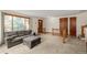 Inviting living room featuring neutral carpet, a large window, and a comfortable gray couch at 4620 W 108Th Pl, Westminster, CO 80031