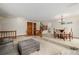 Bright living room with neutral carpet flows into a dining area, offering a welcoming living space at 4620 W 108Th Pl, Westminster, CO 80031