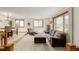 Cozy living room with carpet, comfortable seating, natural light, and a dining area at 4620 W 108Th Pl, Westminster, CO 80031