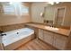 Bathroom with tub, tile countertops and flooring, and white vanity with sink at 23846 Genesee Village Rd, Golden, CO 80401