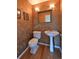 Powder room with pedestal sink, decorative mirror and textured walls at 23846 Genesee Village Rd, Golden, CO 80401
