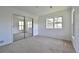 This carpeted bedroom has a mirrored closet and a large window at 23846 Genesee Village Rd, Golden, CO 80401