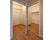 Walk in closet with mirrored doors, wood floor and shelving at 23846 Genesee Village Rd, Golden, CO 80401