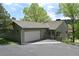 Charming home featuring a two-car garage, well-maintained lawn, and a welcoming front porch at 23846 Genesee Village Rd, Golden, CO 80401