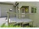 Inviting front porch featuring a cheerful yellow wreath and a gray painted deck at 23846 Genesee Village Rd, Golden, CO 80401