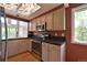 Modern kitchen with stainless steel appliances, dark countertops, and a unique decorative skylight at 23846 Genesee Village Rd, Golden, CO 80401