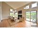 Bright living room featuring a fireplace, plush seating, and a sliding door to the outdoor deck at 23846 Genesee Village Rd, Golden, CO 80401