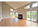 Bright and spacious living room with hardwood floors, fireplace, and access to the outdoor deck at 23846 Genesee Village Rd, Golden, CO 80401