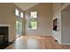 Open-concept living room with hardwood floors, fireplace, and a sliding glass door to the deck at 23846 Genesee Village Rd, Golden, CO 80401