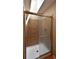 Shower stall with glass door and light brown tiled walls and shower base at 23846 Genesee Village Rd, Golden, CO 80401