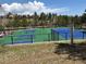 Well-maintained blue and green tennis and pickleball courts in a community setting, perfect for active residents at 23846 Genesee Village Rd, Golden, CO 80401