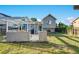 A backyard with a wooden deck, grill, and a spacious lawn, perfect for outdoor enjoyment at 16980 E Stanford Ave, Aurora, CO 80015