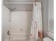 Bathroom features a bathtub, shower, and floral shower curtain at 16980 E Stanford Ave, Aurora, CO 80015