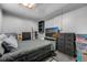 View of bedroom with bed, tv, and storage in a room with a skylight at 16980 E Stanford Ave, Aurora, CO 80015